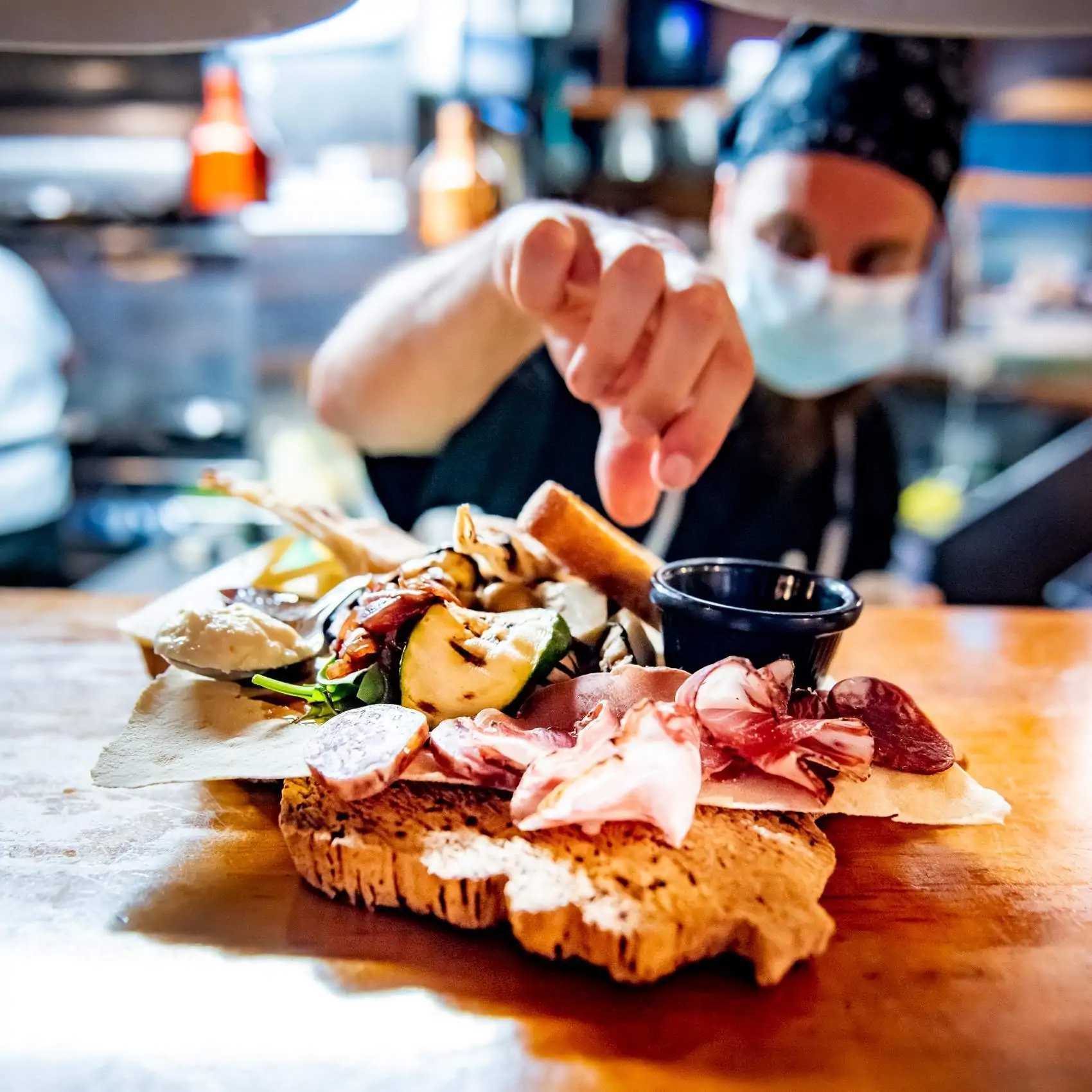 A chef lays the finishing touches to a charcuterie board at Wallace’s Asti, a restaurant in Dublin