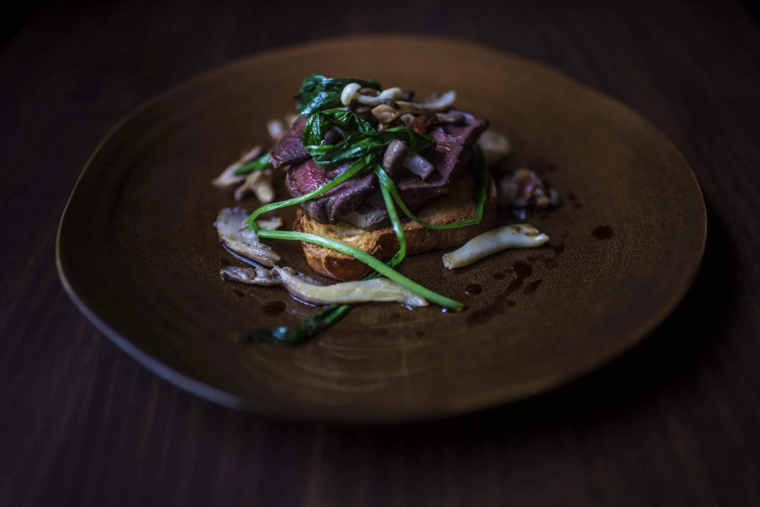 Wood pigeon sits on top of toast with seasonal greens at Camden Kitchen, a restaurant in Dublin