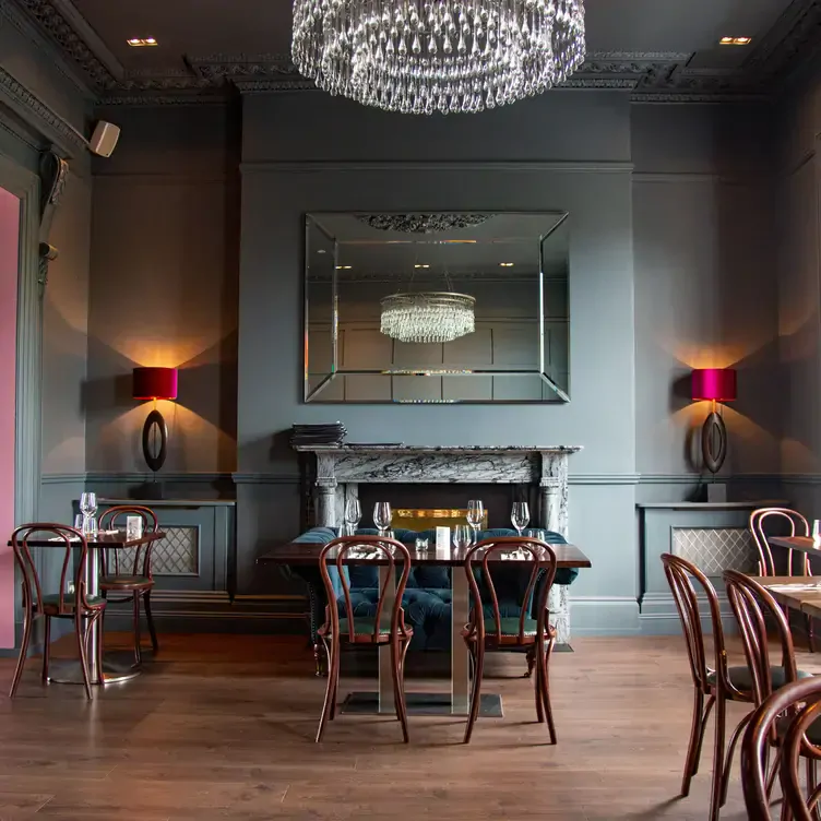 A chandelier illuminates the pale blue walls and cafe-style dining atmosphere at Bon Appetit, one of the most romantic restaurants in Dublin.