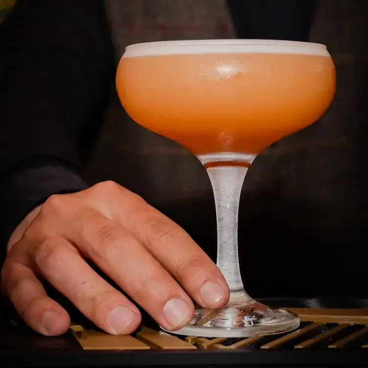 An orange cocktail served at Murray’s Bar.