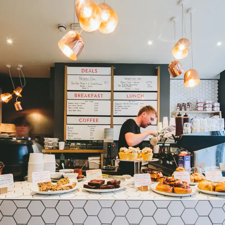 A barista making coffee at Brother Hubbard North, one of Dublin’s best brunch spots.