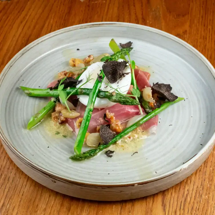 A plate of Eggs Royale with asparagus.