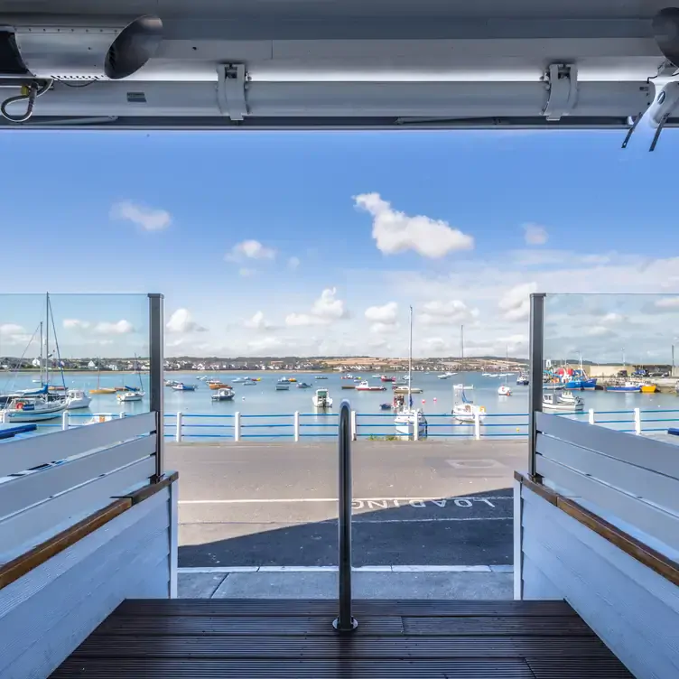 The view from the front door of the Blue Bar, looking out across the road and onto the fishing boats on the bay.