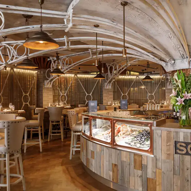 Chic interiors featuring a seafood bar, bright walls and arches on the ceiling at SOLE Seafood & Grill, one of the best seafood restaurants in Dublin.