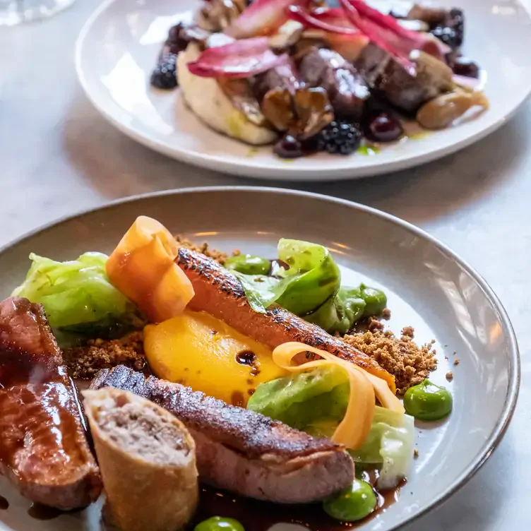 Plates of meat and vegetables at Pichet, one of Dublin’s best fine dining restaurants.