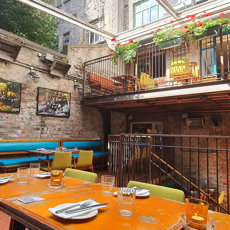 Two-floor interiors with an open terrace at Drury Buildings, a restaurant in Dublin.