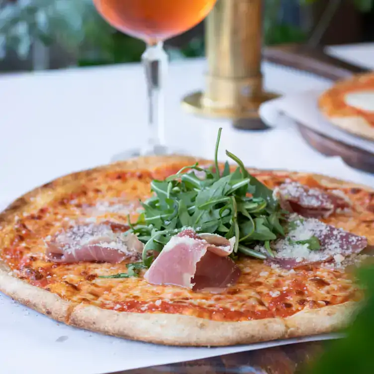 A pizza with ham and rocket at Proof Urban Italian, one of the best bottomless brunch restaurants in Dublin.