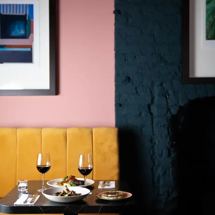 A table for two with glasses of red wine at Lottie’s, one of the best fine dining restaurants in Dublin.