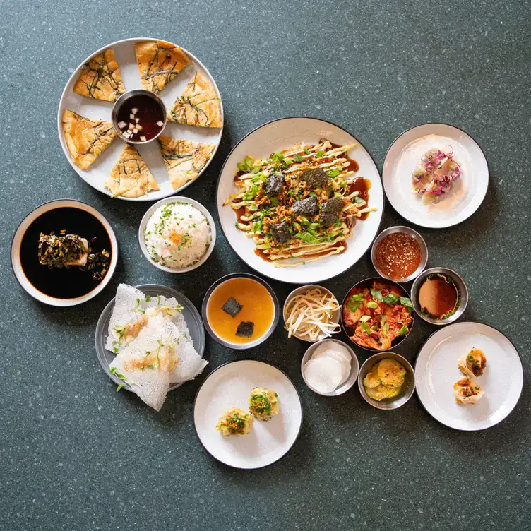 A spread of Asian-inspired dishes featuring rice, soups, sauces and vegetables at Lucky Tortoise, one of the best local restaurants in Dublin.