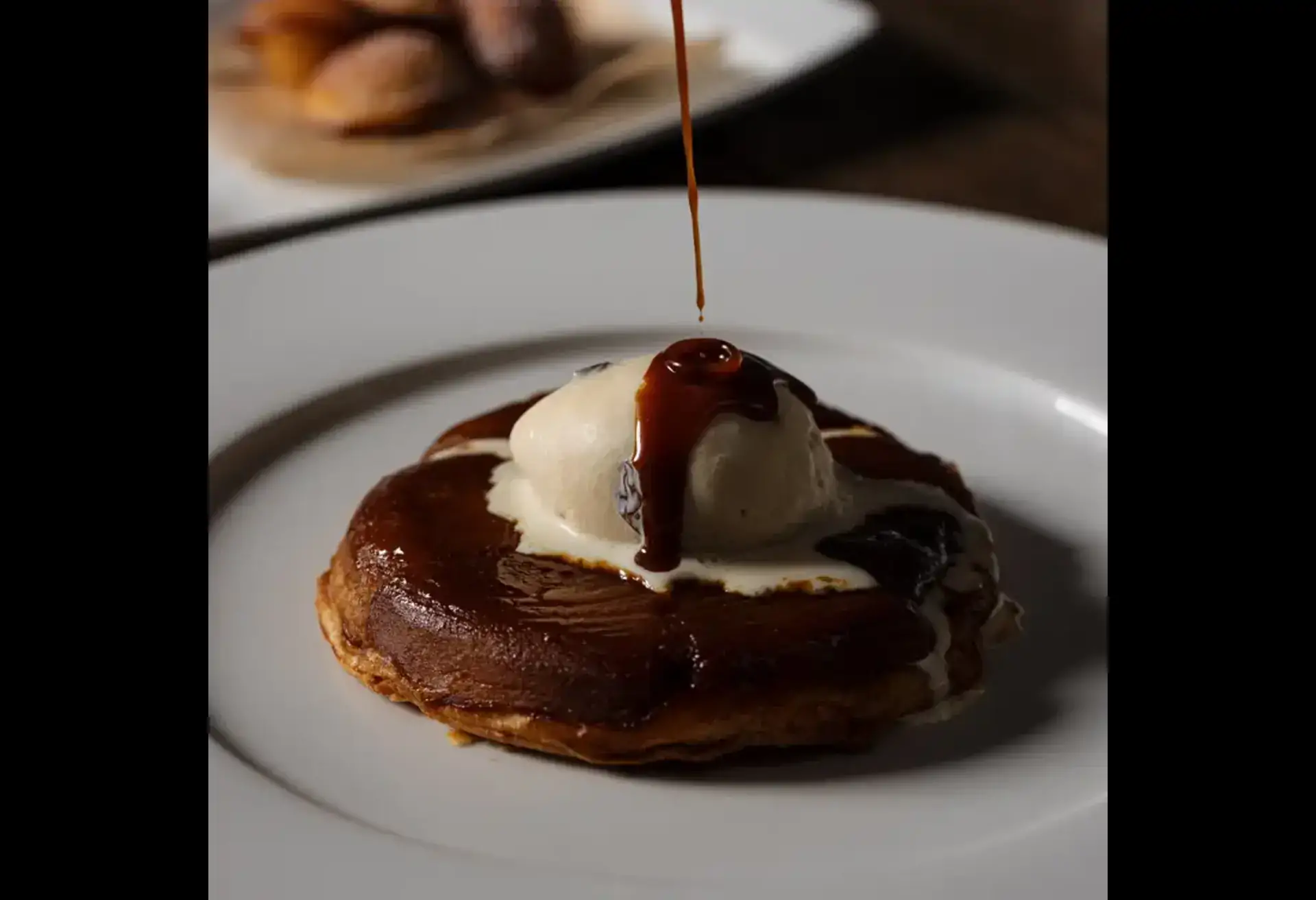 A tarte tatin dessert topped with ice cream and caramel at Marco Pierre White Steakhouse & Grill Dawson Street