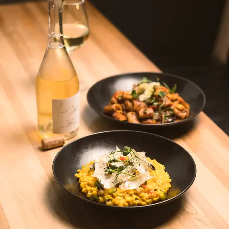 A risotto with shaved cheese and a wine bottle at Sophie’s @ The Dean, one of the best restaurants in Dublin city centre.