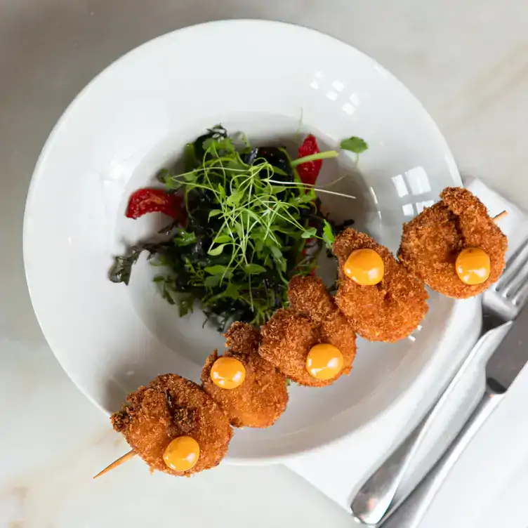 A crumbed skewer served alongside a salad at Roberta’s, one of the best rooftop gardens in Dublin.