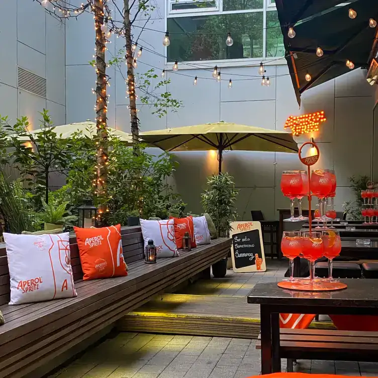 Tables with multi-tiered trays of Aperol Spritzes served at The Green Room, one of the best beer gardens in Dublin.