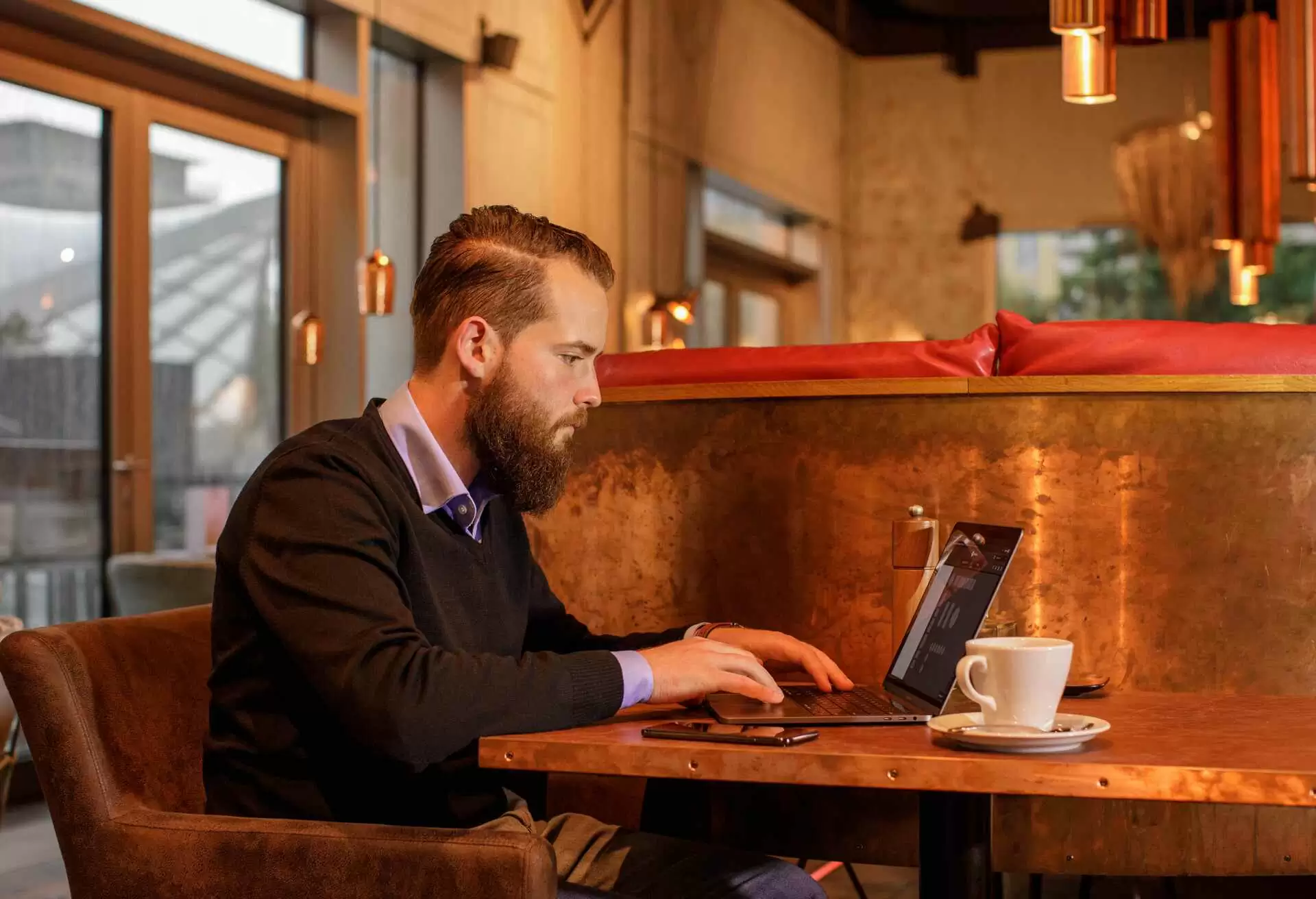 Man working on his laptop in a cafe