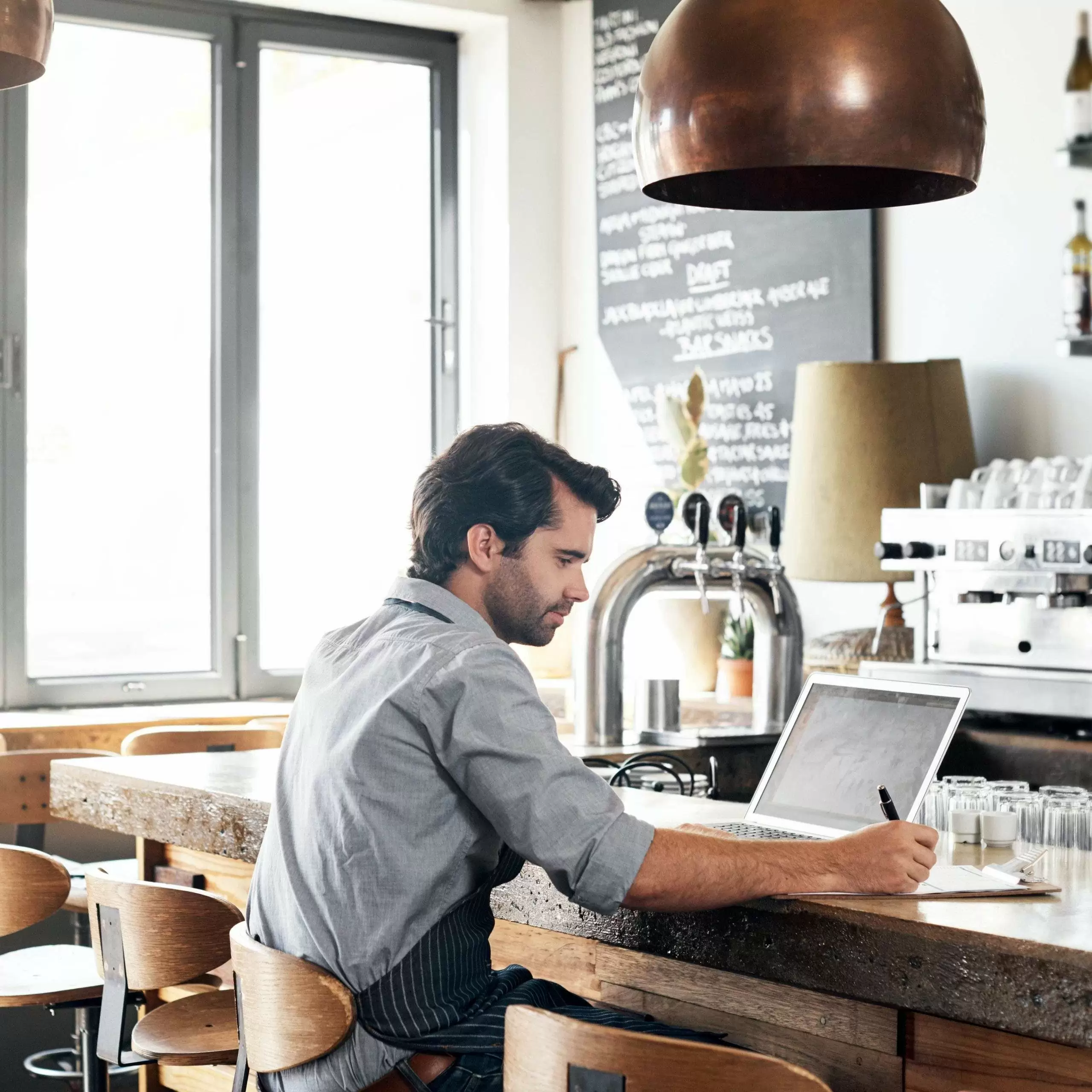 Restaurant owner working on laptop